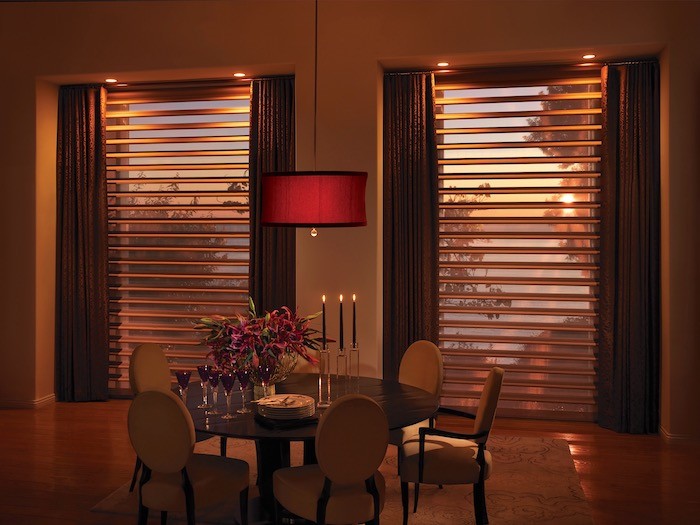 A dining room with flowers and candles.